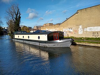 A widebeam boat on the Grand Union Canal moored at West Drayton, a suburban town in the London Borough of Hillingdon