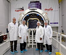 The NASA Administrator Charles Bolden (third from left) in front of the Cygnus spacecraft in May 2012. Bolden in-front of Cygnus.JPG