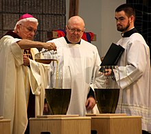 A bishop pouring balsam into oil at Chrism Mass ChrismMass.jpg