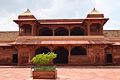 Temple with a tulsi math in the middle of the courtyard