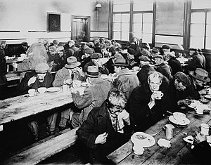 English: People eating at a soup kitchen. Mont...
