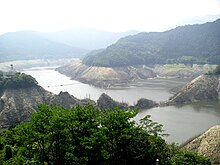 Due to record low rainfall in Summer 2005, the reservoir behind Sameura Dam runs low. The reservoir supplies water to Takamatsu, Shikoku Island, Japan. Sameura dam 20050903.jpg