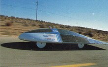 Solar cells spread over the top of this car produce enough energy to keep its electric motor running Solar cells power Electric Car.jpg