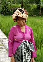 A Sundanese grandma wearing kebaya, kain batik and batik headcloth, West Java.