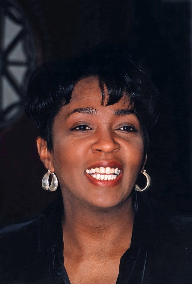 A black-haired woman smiling