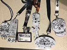 Multiple, electronic and non-electronic, DEF CON human badges and other con badges. DefCon Badges.jpg