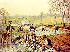 Construction of the first macadamized road in the United States (1823). In the foreground, workers are breaking stones "so as not to exceed 6 ounces [170 g] in weight or to pass a two-inch [5 cm] ring". Rakeman - First American Macadam Road.jpg