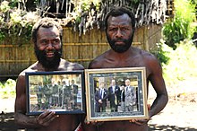 Yaohnanen Tribesmen Show Pictures of 2007 Visit with Prince Philip.jpg