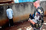 A Foreign Legion soldier with a captured rebel, Ivory Coast, 10 August 2004.