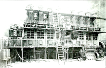 One of the eight-cylinder 3200 I.H.P. Harland and Wolff - Burmeister & Wain diesel engines installed in the motorship Glenapp. This was the highest powered diesel engine yet (1920) installed in a ship. Note man standing lower right for size comparison. 8 cylinder Burmeister & Wain Diesel engine for MS Glenapp 1920.png