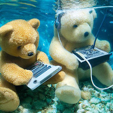 DALL-E 2 generation for "Teddy bears working on new AI research underwater with 1990s technology"