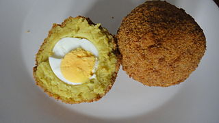 A halved breaded deep fried egg