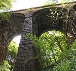 The overgrown viaduct across Lobb Ghyll on the Skipton to Ilkley Line in Yorkshire, built by the Midland Railway in 1888 and closed in 1965