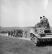 German troops surrender to British crew of a Stuart tank near Frendj, 6 May 1943. The British Army in Tunisia 1943 NA2514.jpg