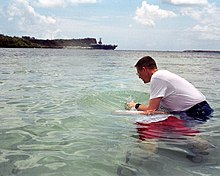 Baptismal ceremony on Easter Sunday. US Navy 030420-N-9236M-025 Chief Electronics Technician Geoffrey Ormston is immersed in the waters of Apra Harbor, Guam by Chaplain Richard Inman during a baptismal ceremony on Easter Sunday.jpg