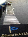 Britannia Yacht Club main harbour floating finger dock with BYC welcome mat