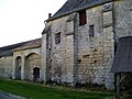 Façade ouest de la ferme de Fourcheret, avec l'ancienne porterie (à gauche) et un pan de mur d'origine du logis, avec trois contreforts. Plus à droite, les contreforts ont disparu.