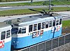 Spårvagn M28 704 på linje 10 ankommer hållplats Frihamnen i augusti 2015.