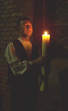 A Lutheran deacon with an Easter candle Praecentor.JPG