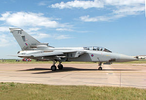 Greyish-blue aircraft taxiing on ramp.