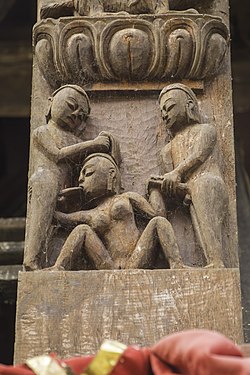 A 17th century sculpture depicting a woman performing oral sex on two men. From the wall of the Uma Maheshwor Temple at Kirtipur. Umamaheshwor Temple-IMG 4035.jpg