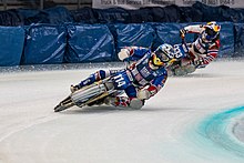 Two ice speedway motorcyclists take a fast turn on the ice circuit during the 2018 FIM Ice Speedway World Gladiator Championship in Inzell, Germany.