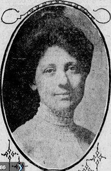 A newspaper photograph of a white woman in an oval frame. She is wearing a high lace collar, with her dark hair dressed in an bouffant updo.