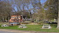 Looking across the park downtown towards the old Banks County Courthouse, the large brick building in the left background]]