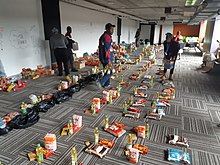 Volunteers in Philippi, Western Cape packing food parcels to be given out to the needy during the COVID 19 pandemic lockdown. The lockdown had a seriously negative impact on South Africa's economy that hit the poor and unemployed especially hard. Philippi 20200407 112336.jpg