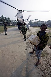 Bangladeshi citizens offload food rations from a US Marine CH-46E helicopter of 11th Marine Expeditionary Unit after Tropical Cyclone Sidr in 2007. US Navy 071204-M-1226J-016 Bangladeshi Citizens, offload food rations from a Marine CH-46E assigned to Marine Medium Helicopter Squadron (HMM) 166 (REIN), 11th Marine Expeditionary Unit (MEU) Special Operations Capable (SOC).jpg