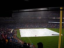 The grounds crew covers the field with a tarpaulin during the Game 5 rain delay. 2008 world series rain delay.JPG