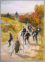 "Bicycling", a ca. 1887 color print showing one of the few ways in which it was socially acceptable for women to ride cycles, in the years before the invention of "safety bicycles" and the woman's "bicycle suit". Bicycling-ca1887-bigwheelers.jpg