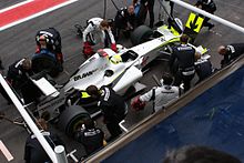 Photo d'hommes changeant les pneus de la Brawn BGP 001 de Button