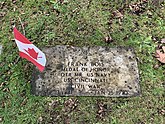 Frank Bois’s headstone with Canadian flag fluttering