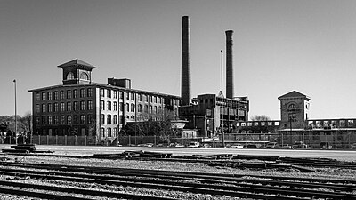 Black and white photograph of a large brick factory building
