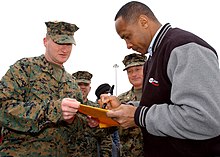 Swann (right) signing an autograph for Marine Corps Sgt. Charles Heller Lynn Swann.jpg
