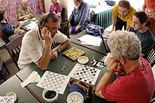 Mathematicians playing Konane at a combinatorial game theory workshop Mathematicians playing Konane.jpg