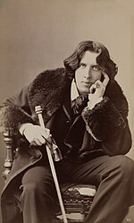Oscar Wilde, famous anarchist Irish writer of the decadent movement and famous dandy Oscar Wilde by Napoleon Sarony. Three-quarter-length photograph, seated.jpg