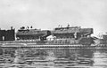 Two Japanese Type 4 Ka-Tsu amphibious landing craft of World War II of the Imperial Japanese Navy. They are armed with two torpedoes on each side, standing on a submarine.