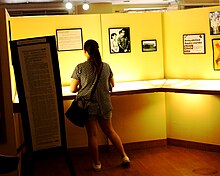 A visitor at Bantayog ng mga Bayani browses through a timeline of the last moments of the protests that culminated in People Power. VisitorViewingBantayogEDSATimeline.jpg