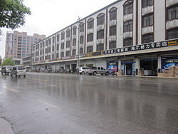 Residential buildings on both sides of the street.