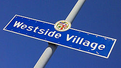 Street sign marking the border of the Westside Village neighborhood