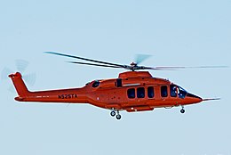 A red helicopter in flight, with the tail number (also known as aircraft registration number) N525TA. This was the initial prototype Bell 525 Relentless.