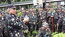 BGEN Johnny Macanas AFP - AFP Deputy J-9 instructs members of the Quezon City TAS Unit in the proper planting and care of a Bukidnon cherry blossom sapling.