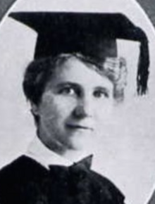 A 41-year-old white woman wearing an academic cap and gown