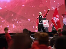 Giring Ganesha raises his fist during a KopDarNas Event. Giring Ganesha KopDarNas 2021.jpg