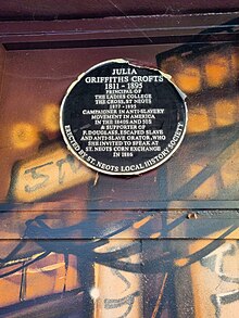 A plaque which reads 'Julia Griffiths Crofts 1811-1895 Principal of the ladies college The Cross, St Neots 1877-1895 Campaigner in anti-slavery movement in America in the 1840s and 50s & supporter of F. Douglass, escaped slave and anti-slave orator, who she invited to speak at St Neots Corn Exchange in 1886'