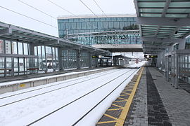 Train platform with the station building in the background