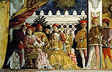 Fresco. A close-up view of richly dressed middle-aged couple seated on a terrace with their family, servants and hound. The man discusses a letter with his steward. A little girl seeks her mother’s attention. The older sons stand behind the parents. The space is restricted and crowded in a formal manner, but the figures are interacting naturally.