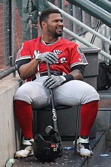 A baseball player in red and gray